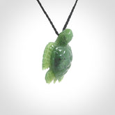 British Columbian jade turtle pendant. Hand carved jade turtle pendant, made by NZ Pacific for sale online. Unique handmade jewellery. Provided with an adjustable cord and packaged in a woven kete pouch.